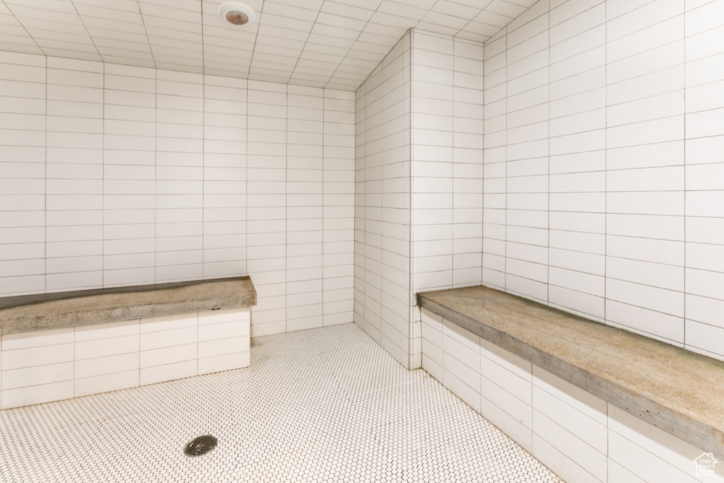 Bathroom featuring tile walls