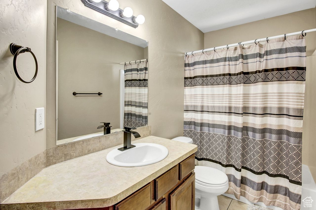 Bathroom featuring vanity, a shower with shower curtain, and tile patterned flooring
