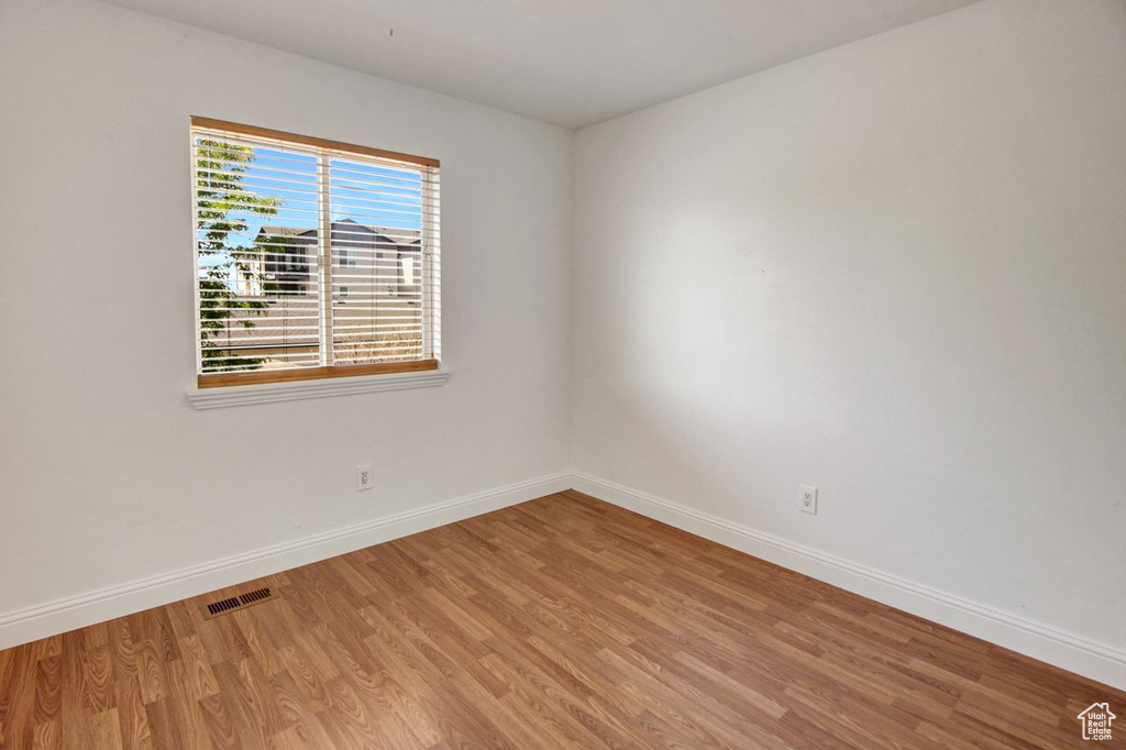Unfurnished room with light wood-style flooring and baseboards