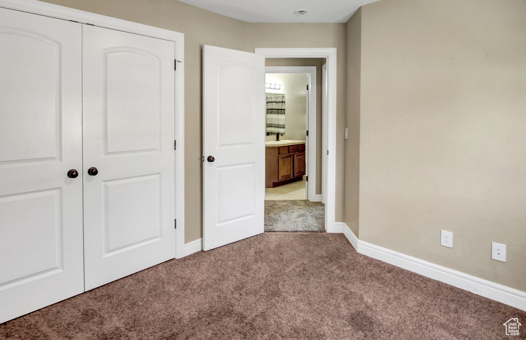 Unfurnished bedroom featuring carpet floors and a closet