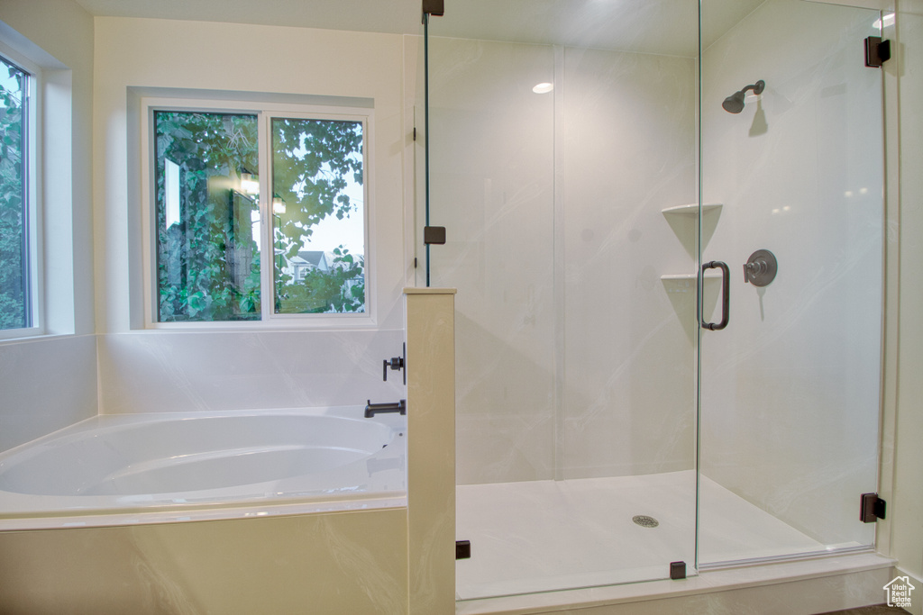 Bathroom featuring a stall shower and a garden tub