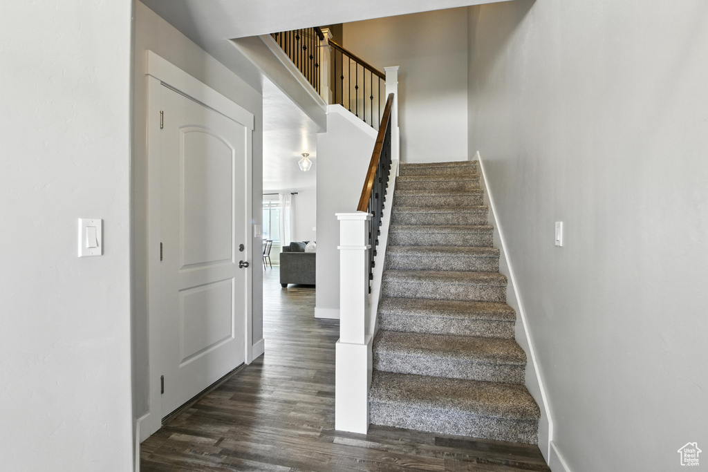 Staircase featuring wood finished floors and baseboards