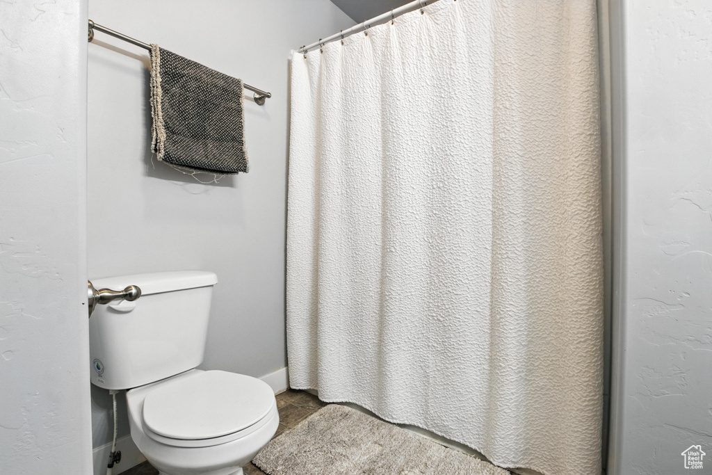 Bathroom featuring tile patterned flooring and curtained shower