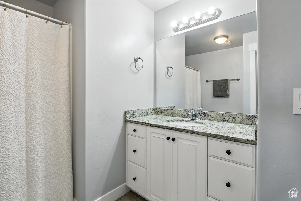 Full bathroom with vanity and a shower with shower curtain