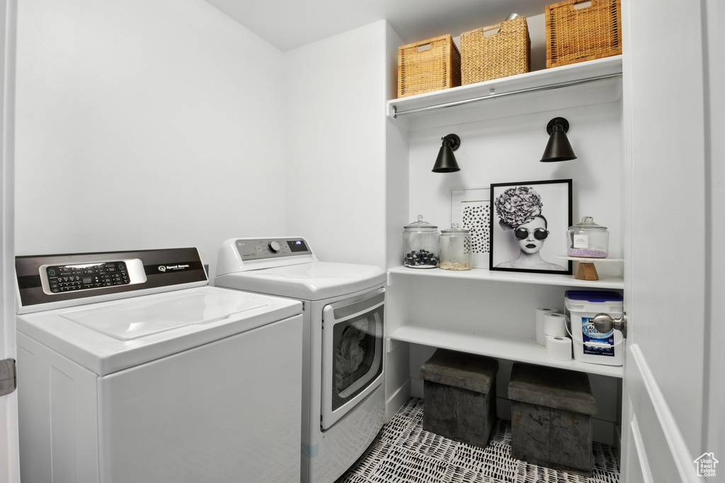 Laundry area featuring washer and dryer and tile patterned floors
