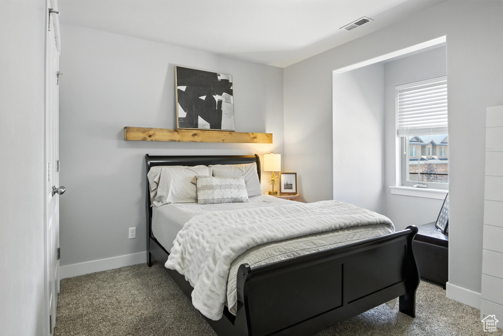 Carpeted bedroom with baseboards