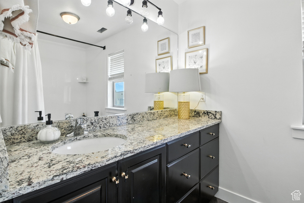 Bathroom with vanity and a shower with curtain