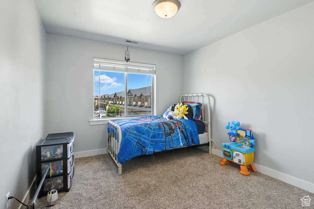 Carpeted bedroom with baseboards