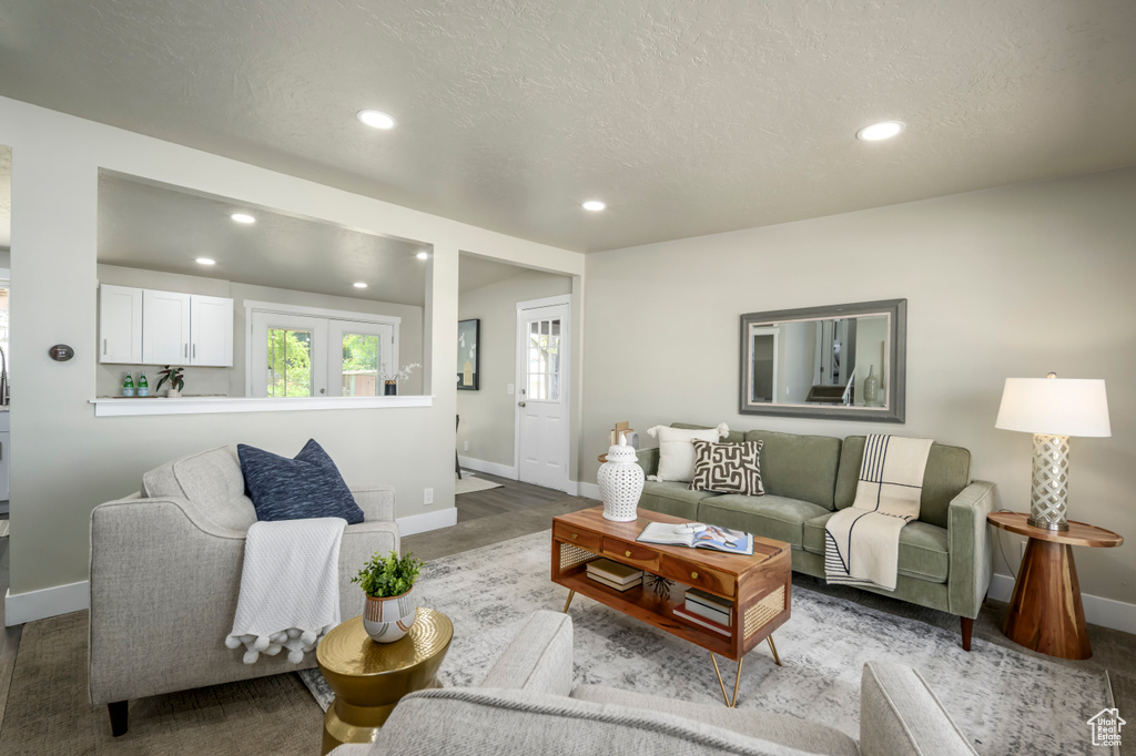 Living area featuring recessed lighting and a textured ceiling