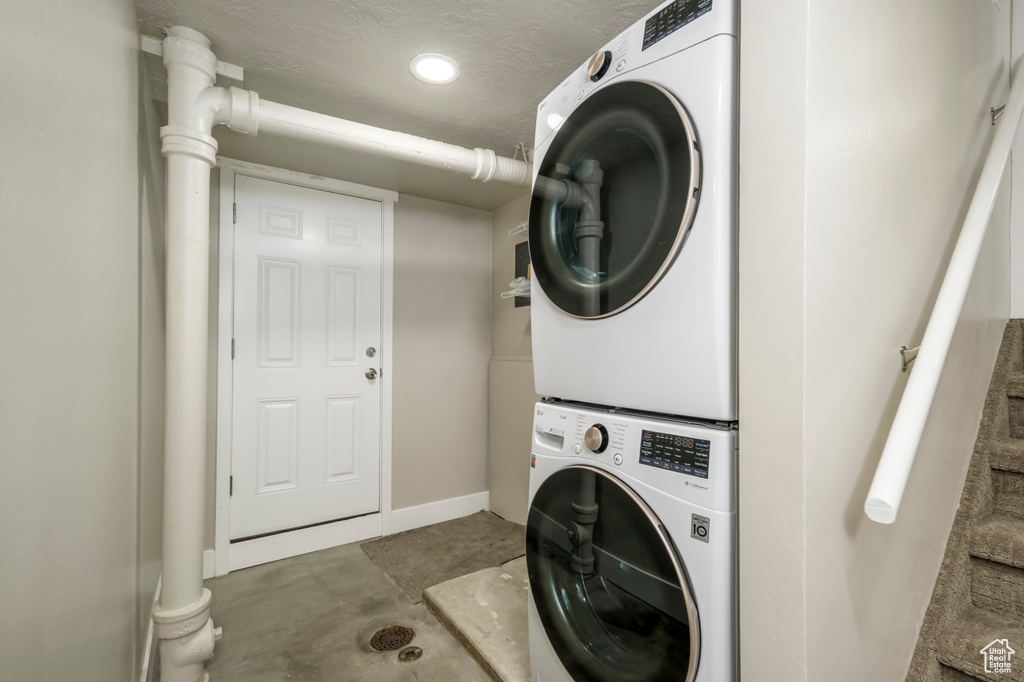 Laundry area with stacked washer / dryer and recessed lighting