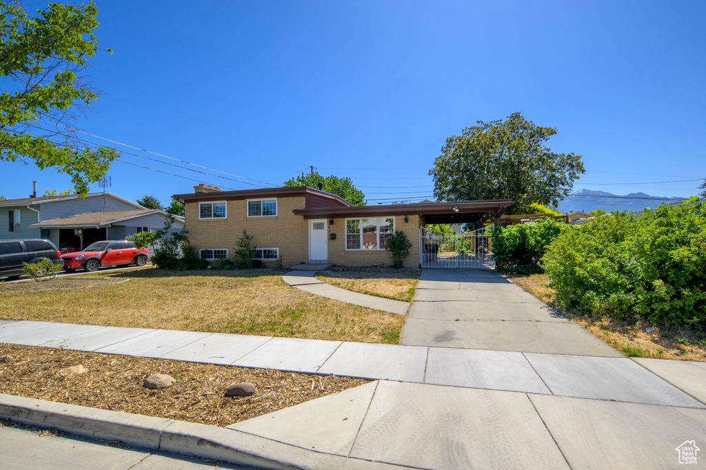 Split level home featuring driveway and a carport