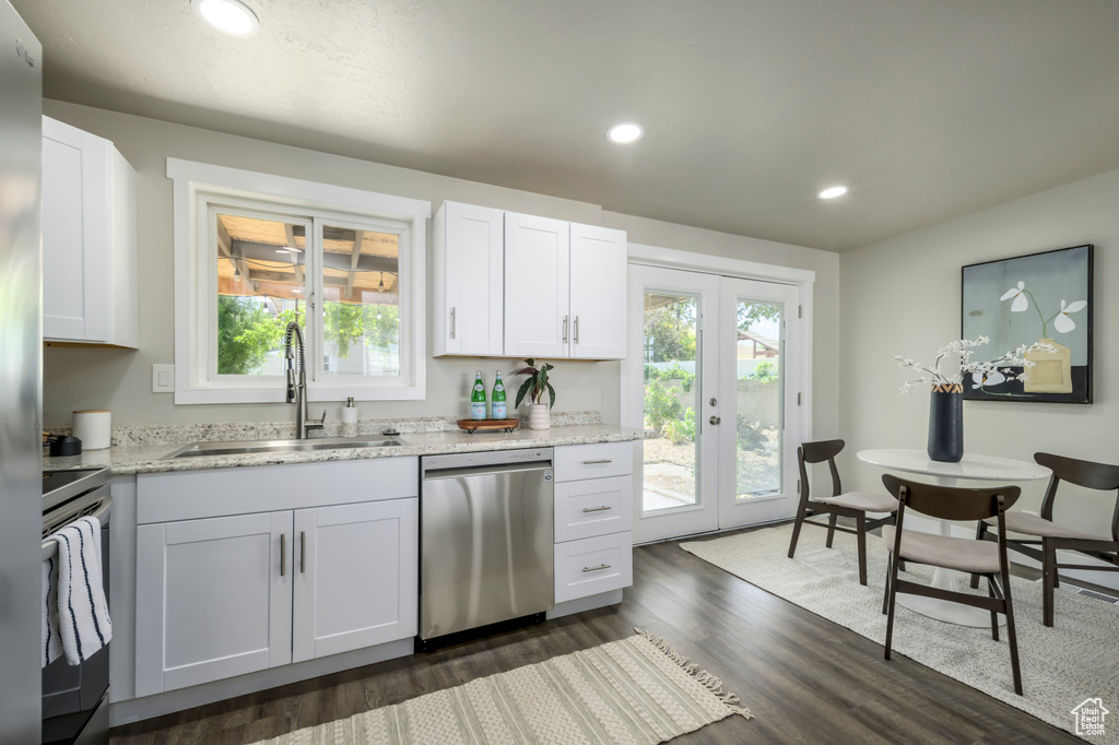 Kitchen with stainless steel dishwasher, electric range, french doors, recessed lighting, and dark wood-style flooring