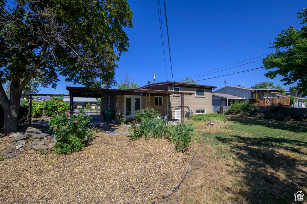 Back of property with french doors and brick siding