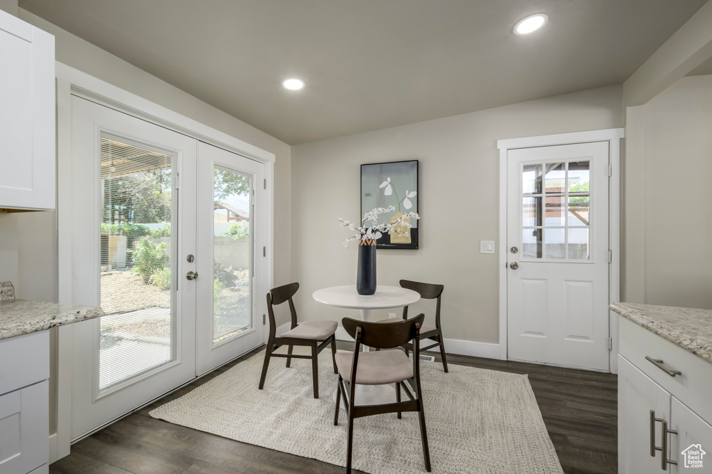 Dining room featuring french doors, healthy amount of natural light, dark wood-type flooring, and recessed lighting