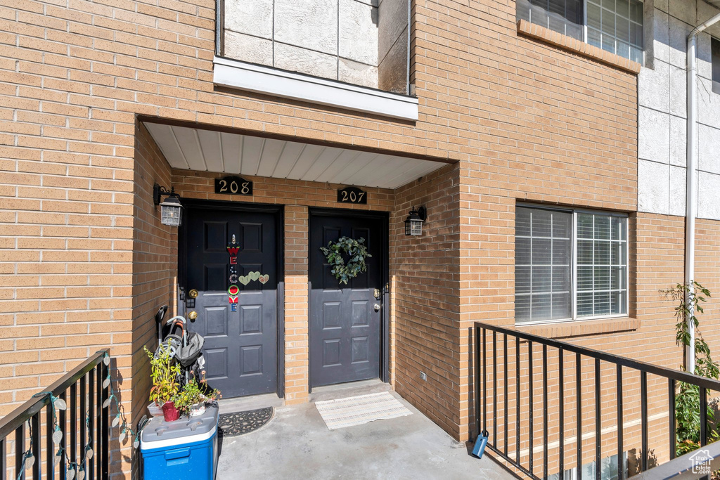 Doorway to property with brick siding