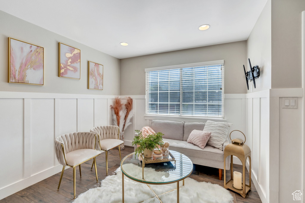 Living area with a decorative wall, a wainscoted wall, wood finished floors, and recessed lighting