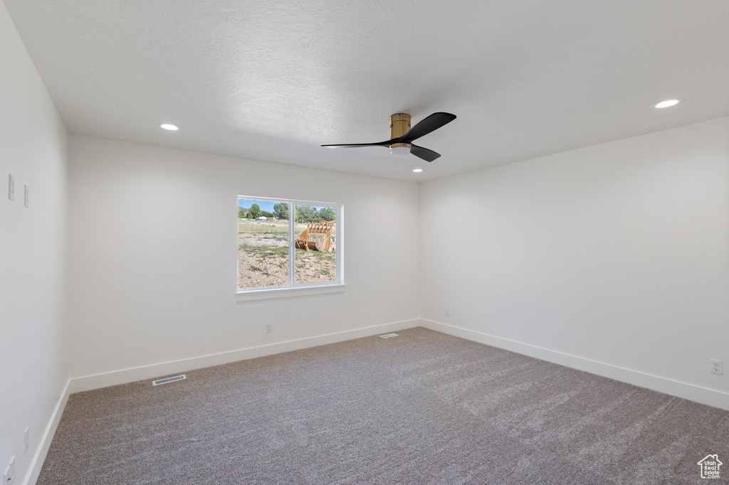Spare room featuring a ceiling fan, recessed lighting, and carpet