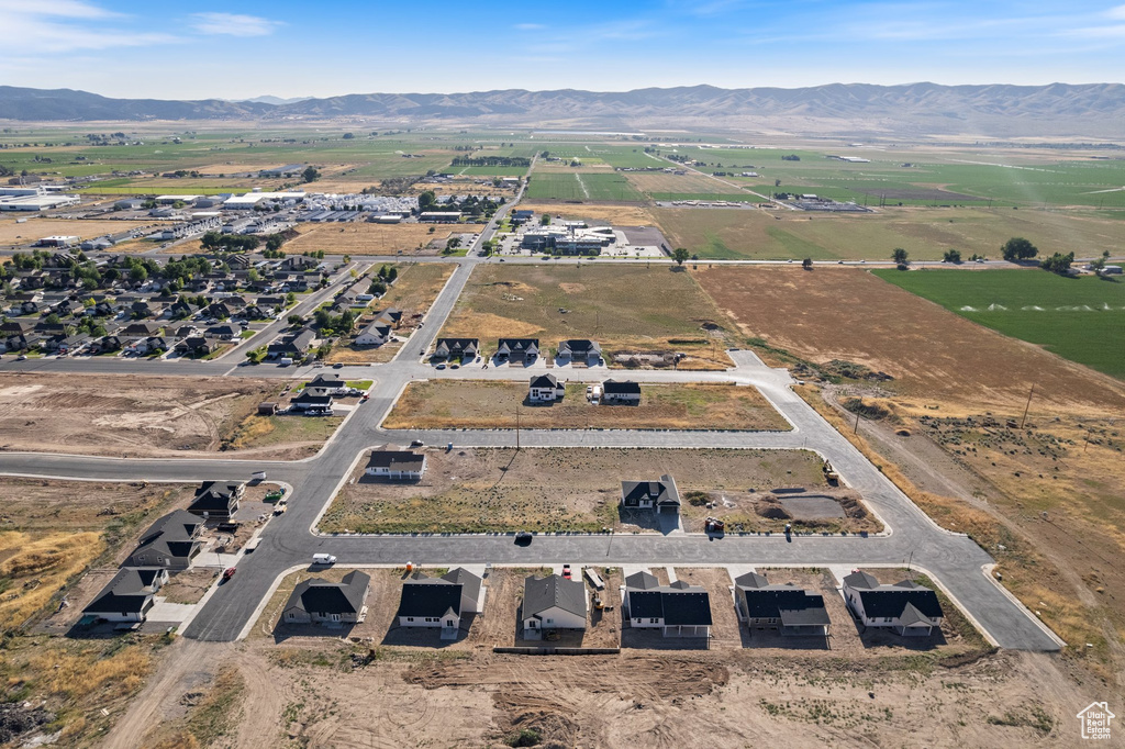 Aerial overview of property\'s location with a mountain backdrop and rural landscape