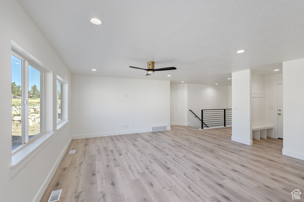 Empty room with light wood-style floors, recessed lighting, and ceiling fan