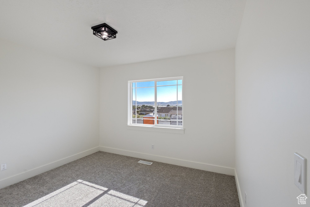 Unfurnished room with carpet and baseboards