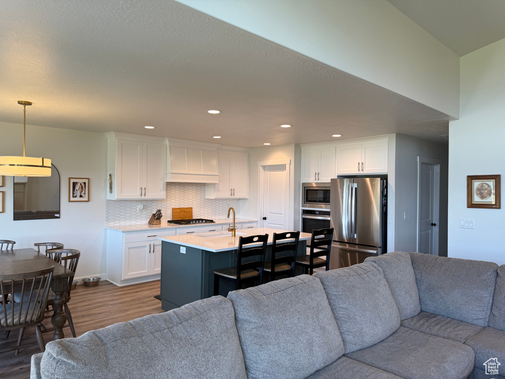 Living room featuring dark wood-style floors and recessed lighting