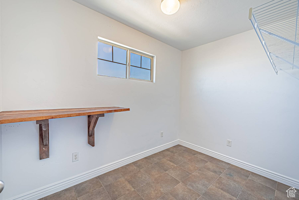 Unfurnished room featuring baseboards