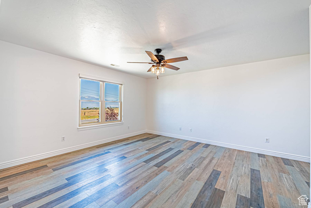 Spare room with ceiling fan and light wood finished floors