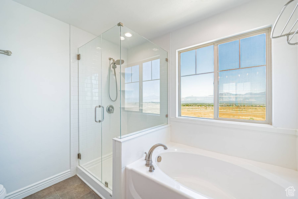 Bathroom with a garden tub, a stall shower, tile patterned floors, and recessed lighting