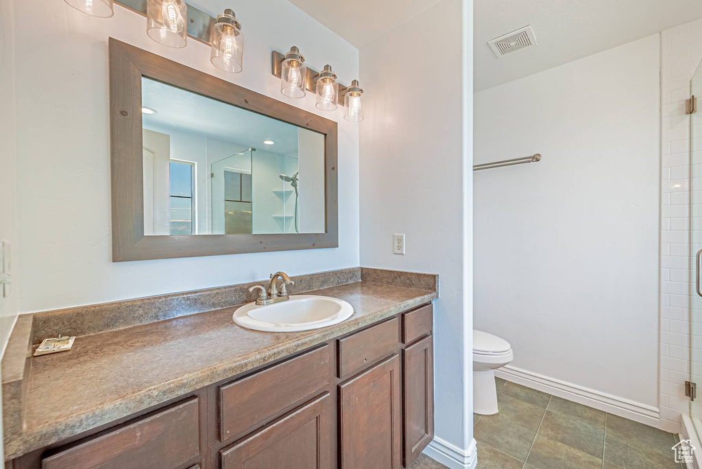 Bathroom featuring vanity and a shower with shower door