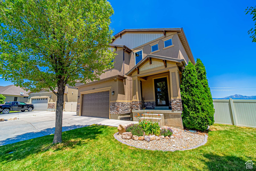 Craftsman-style home with stone siding, concrete driveway, stucco siding, and a garage