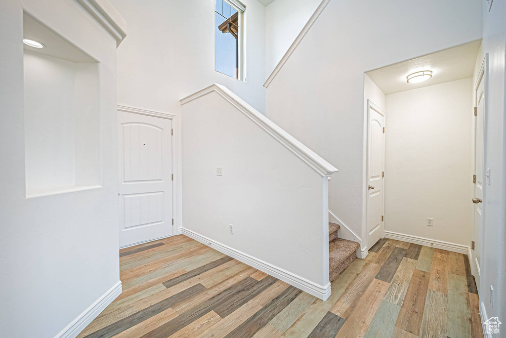 Foyer with light wood-type flooring and stairs