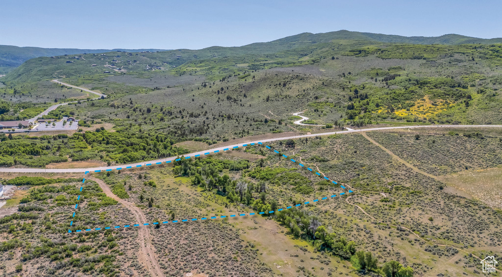 Aerial view of sparsely populated area featuring property parcel outlined and mountains