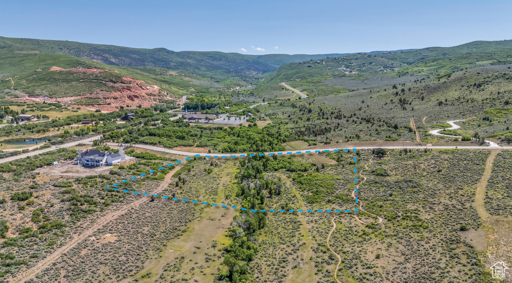 View of rural area featuring a mountainous background and property parcel outlined