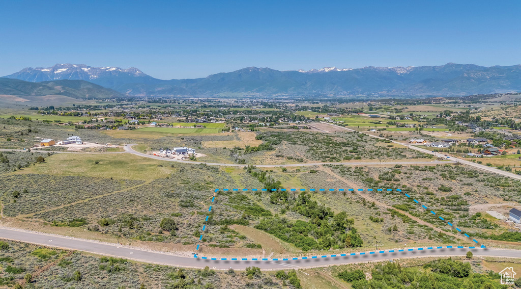 Overview of rural landscape featuring property boundaries highlighted and a mountainous background