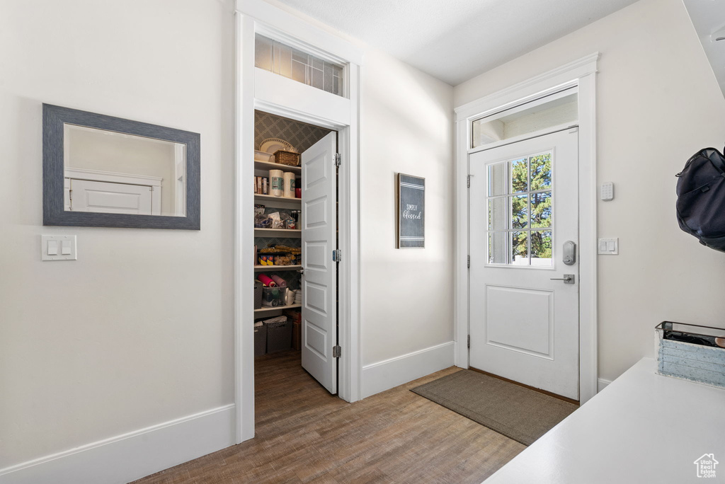 Entrance foyer featuring wood finished floors and baseboards