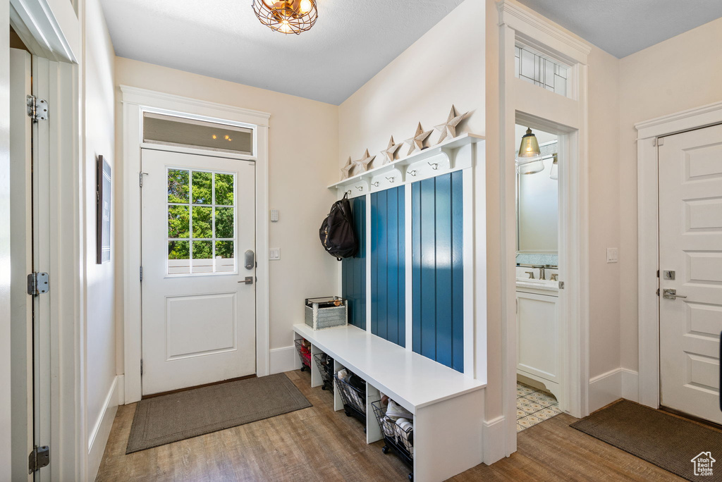 Mudroom with wood finished floors and baseboards