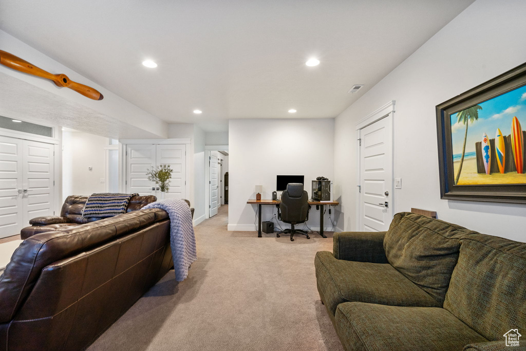 Living room featuring a desk, recessed lighting, and light colored carpet