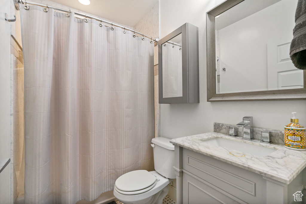 Full bath featuring vanity and a shower with shower curtain