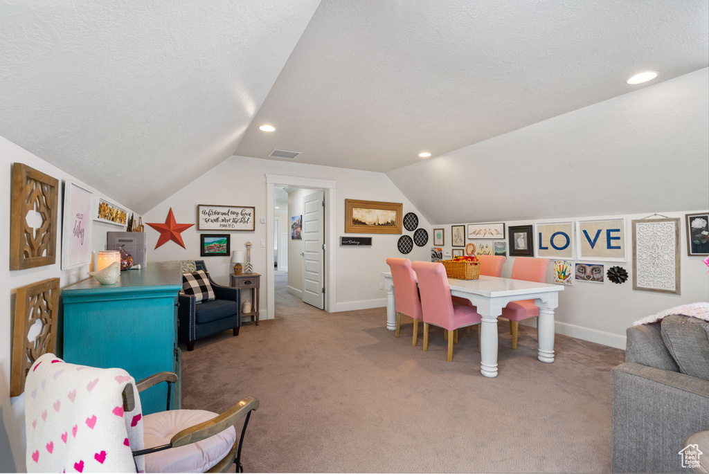 Playroom featuring lofted ceiling, carpet flooring, recessed lighting, and a textured ceiling