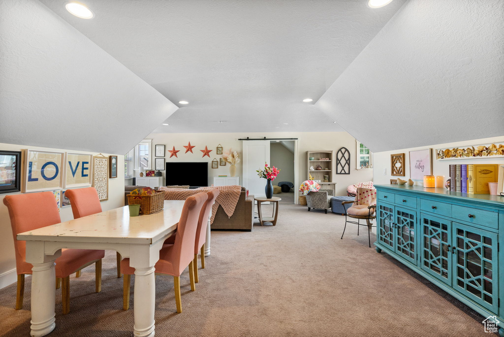 Carpeted dining area featuring lofted ceiling, healthy amount of natural light, and recessed lighting