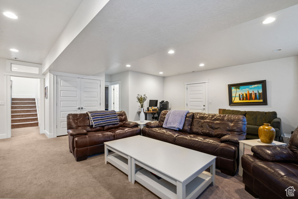 Carpeted living area featuring recessed lighting, stairway, and an office area
