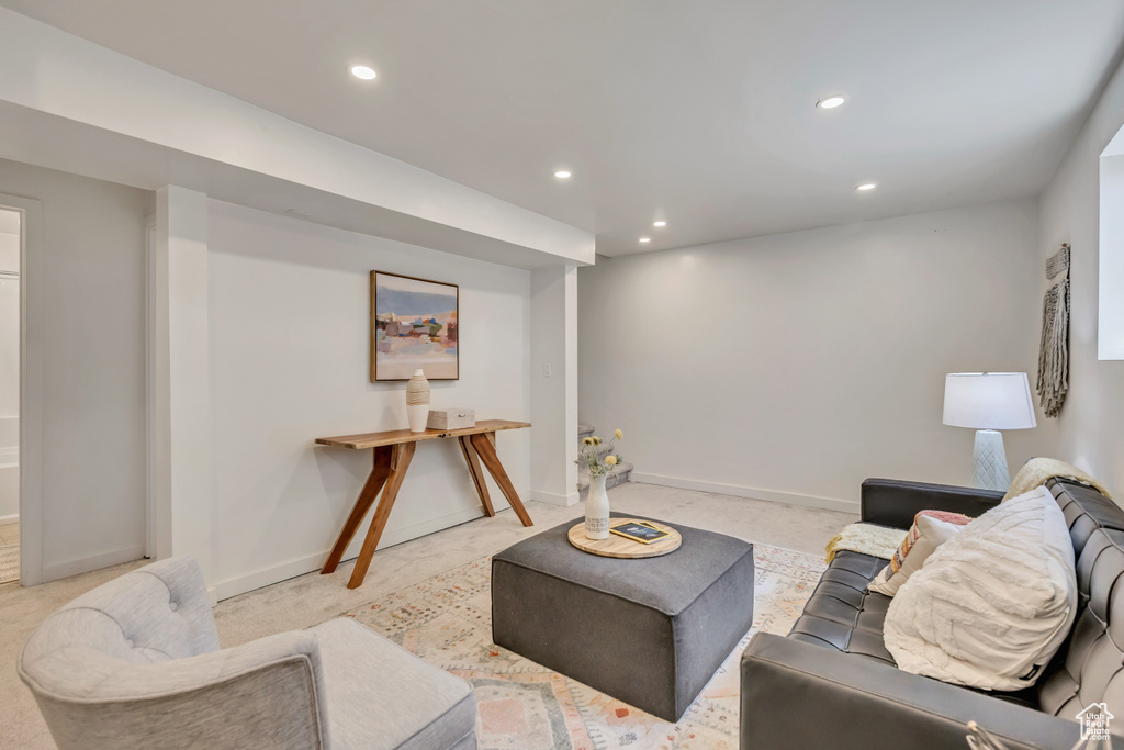 Living room with recessed lighting and light colored carpet