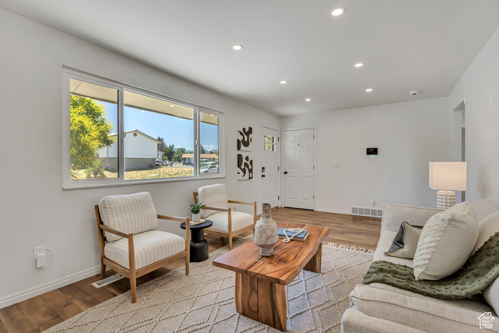 Living area featuring light wood-style floors and recessed lighting