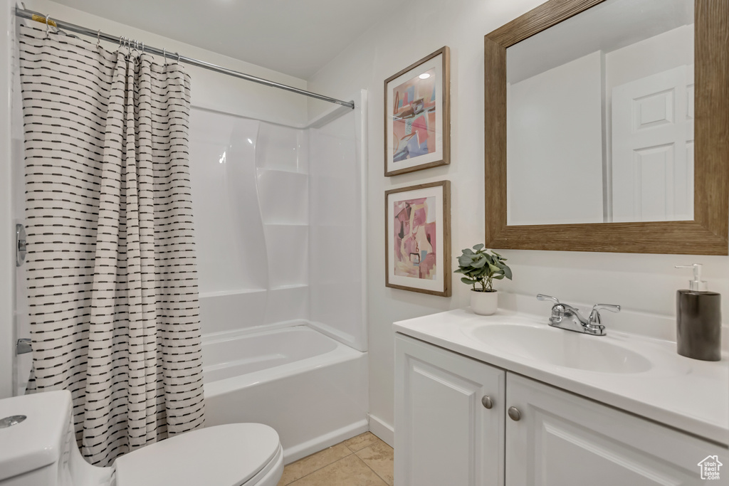 Bathroom featuring vanity, tile patterned floors, and shower / bath combination with curtain