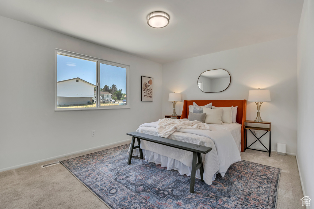 Carpeted bedroom featuring baseboards