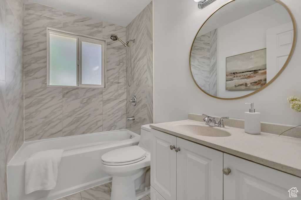 Full bath with vanity, bathing tub / shower combination, and marble finish flooring