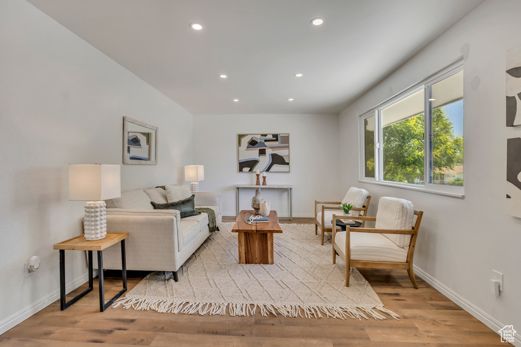 Living room with recessed lighting and wood finished floors