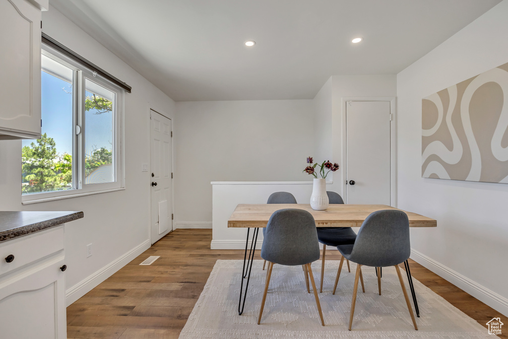 Dining room featuring wood finished floors and recessed lighting