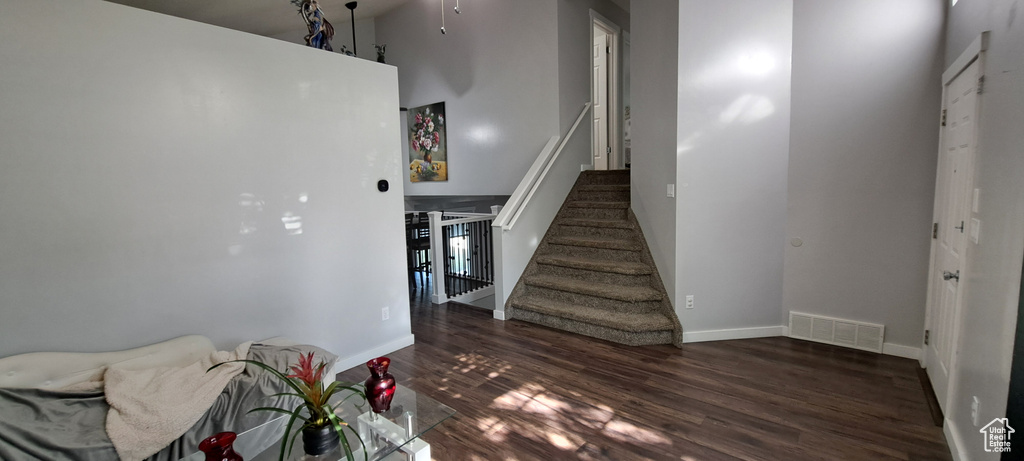 Stairs featuring wood finished floors and a ceiling fan