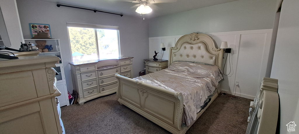 Bedroom with dark carpet and ceiling fan